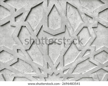 Flat-lay background of an Islamic geometric pattern carved into raw, grey concrete. The intricate, repeating lines and stars create a modern, minimalist texture. Perfect for Islamic architecture