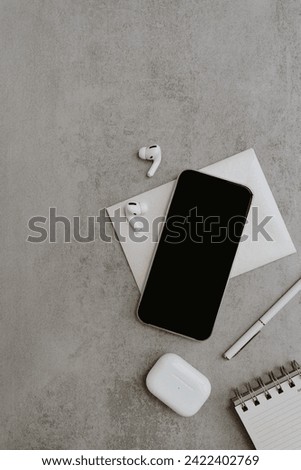 Flatlay of blank clipping path screen mobile phone, wireless earphones. Online shop, store, blog template with mockup space. Flat lay, top view