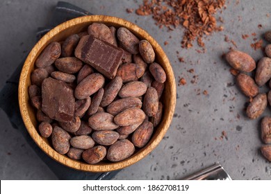 Flatlay Cocoa Beans, Cocoa Powder, Raw Chocolate On A Gray Background. The Concept Of Healthy Eating. 