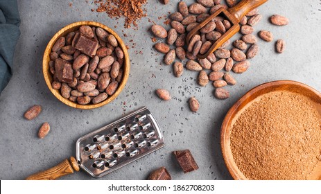 Flatlay Cocoa Beans, Cocoa Powder, Raw Chocolate On A Gray Background. The Concept Of Healthy Eating. 