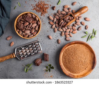 Flatlay Cocoa Beans, Cocoa Powder, Raw Chocolate On A Gray Background. The Concept Of Healthy Eating. 