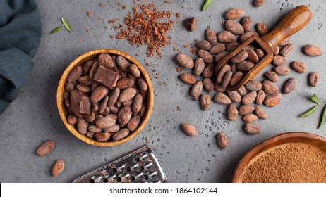 Flatlay Cocoa Beans, Cocoa Powder, Raw Chocolate On A Gray Background. The Concept Of Healthy Eating. 