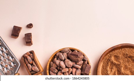 Flatlay Cocoa Beans, Cocoa Powder, Raw Chocolate On A Pink Background. The Concept Of Healthy Eating. Copy Space.