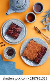 Flatlay Color Creative Food Photography, Brownies And Tea Top Down On Solid Color Block