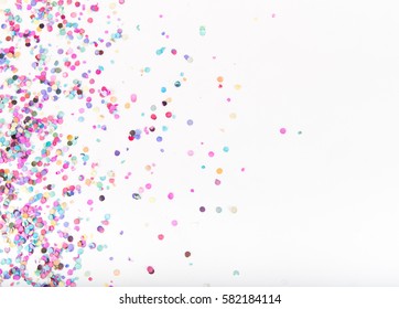 Flatlay of Colorful Round Paper Confetti on White Paper