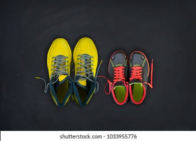 Flatlay Composition Of Fitness Sneakers For Him And For Her On A Black Background. Concept Of Healthy Lifestyle, Sport And Activity.