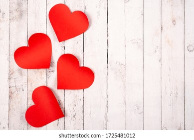 Flatlay composition with hearts on a wooden background
