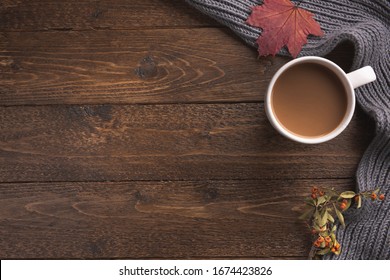 Flatlay Composition With Knitted Scarf, Cup Of Coffe On Wooden Desk Table. Hygge Style, Cozy Autumn Or Winter Holiday Concept. Flat Lay, Top View, Overhead.