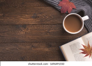 Flatlay Composition With Knitted Scarf, Cup Of Coffe, Book, And Yellow Leaves On Wooden Desk Table. Hygge Style, Cozy Autumn Or Winter Holiday Concept. Flat Lay, Top View, Overhead.