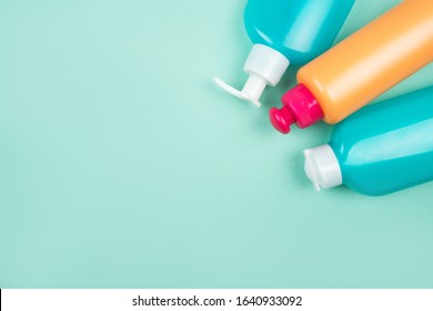 Flatlay With Cosmetic Packaging Plastic Bottles Isolated On Blue Background. Plastic-free Concept.