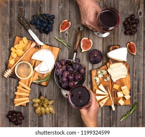 Flat-lay Of Couple Hands Or Friends Enjoying Wine, Eating And Drinking Together. People Having Party, Celebrating At Wooden Rustic Table. Cheese Plate Served With Wine, Grapes, Fig And Honey. 