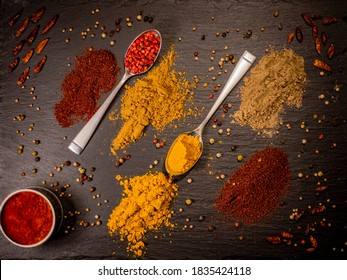 Flatlay From Different Spices Of Pepper And Two Spoons