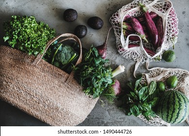 Flat-lay of of grocery jute and net bags full of fresh vegetables, greens, fruit from local farmers market over grey concrete background. Zero waste, healthy, eco-friendly, vegan, clean eating concept - Powered by Shutterstock