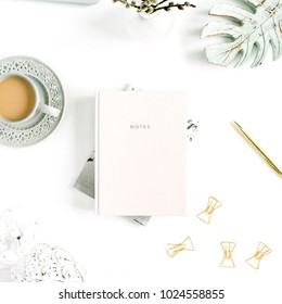 Flatlay Of Home Office Desk Table. Workspace With Pale Pastel Pink Notebook And Decorations On White Background. Flat Lay, Top View. Woman Home Office.