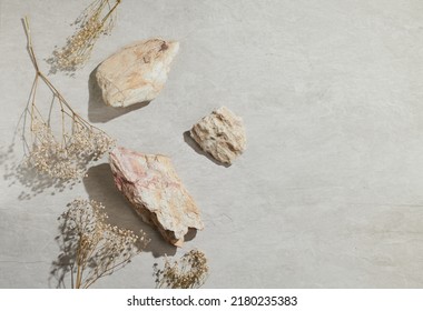 Flatlay minimal natural stone, marble or travertino surface background with stones and dry flowers. Template for showcase, presentations, branding, web desing, posts. - Shutterstock ID 2180235383
