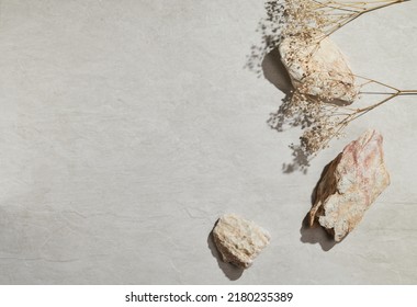 Flatlay minimal natural stone, marble or travertino surface background with stones and dry flowers. Template for showcase, presentations, branding, web desing, posts. - Shutterstock ID 2180235389