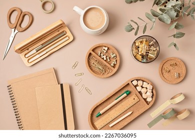 Flatlay of office supplies made of recycled materials on beige background. Flat lay, top view photo mock up.