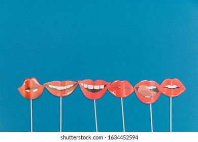 flatlay overhead top paper photo booth props red lips on blue background copy space.