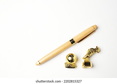 Flatlay Picture Of Pen With Miniature Golden Ball And Boots On Copyspace White Background. Signing Player And Transfer Window Concept.