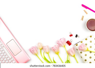 Flatlay with pink tulips, a laptop, cup of tea and other accessories. Spring business mockup, white background