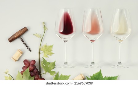 Flat-lay Of Red, Rose And White Wine In Glasses And Branch Of Grape Vine On White Background. Wine Bar, Winery, Wine Degustation Concept. Minimalistic Trendy Photography