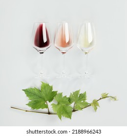 Flat-lay Of Red, Rose And White Wine In Glasses And Vine Branch On White Background. Wine Bar, Winery, Wine Degustation Concept. Minimalistic Trendy Photography