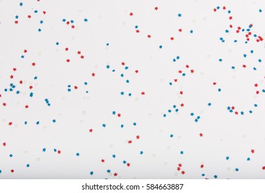 Flatlay Of Red, White, And Blue Star Shaped Sprinkles With Room For Text