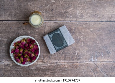 Flatlay Rustic Aromatherapy Display Of Bowl Of Rose Buds And Small Artisan Candle And Hand Made Artisan Soap Still Life