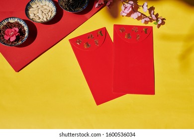 Flatlay Of Tet Celebration Table With Lucky Money Envelopes And Bowls Of Various Seeds