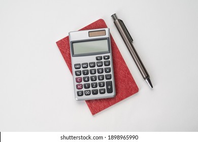 Flatlay Topview Of Working Table Including Pen , Note , Calculator And Sticky Note Isolated 