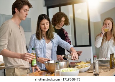 Flatmates cooking together at home