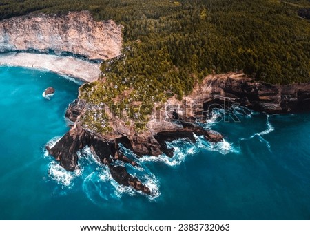 Flatrock, NL, Canada Turquoise sea coast surrounded by rocky cliff covered with lush trees
