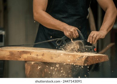 flattening a raw wood by using an electric planer - Powered by Shutterstock