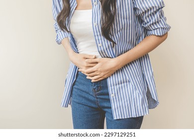 Flatulence asian young woman intolerance hand in stomach ache, suffer from food poisoning, abdominal pain and colon problem, gastritis or diarrhoea when at home. Patient belly, abdomen or inflammation - Powered by Shutterstock