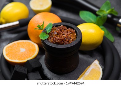 Flavored Tobacco For Hookah And Fruits On A Black Stone Background