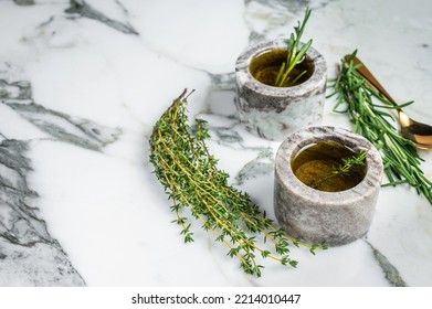 Flavoring: Extra Virgin Olive Oil With Thyme And Rosemary. Top View. White Background. Copy Space.