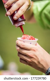 Flavouring A Raspberry Snow Cone Shawed Ice In A White Cup