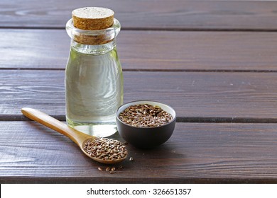 Flax Seed Oil In Glass Bottle On A Wooden Table