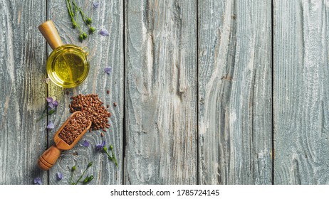 Flax seeds and flax oil. Brown linen seeds and flaxseed oil on old gray wooden background. Copy space. Top view or flat lay.