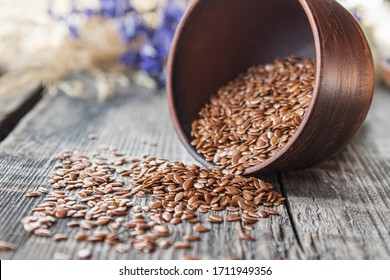 Flax seeds are on old boards, near the bowl. Flaxseed is used to prevent heart disease and being overweight.
