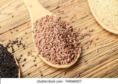 Flax seeds. Wooden spoon on a wooden table. Rustic style.