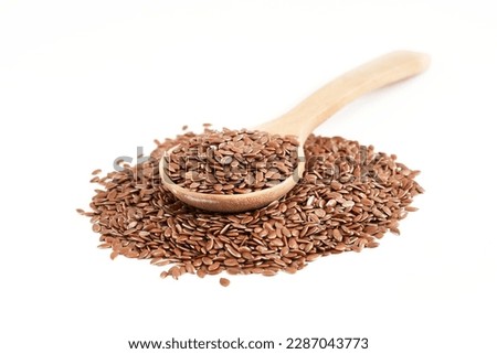 flaxseed or linseed in wood spoon isolated on white background. close up flaxseed or linseed in wood spoon isolated on white background. flaxseed or linseed in wood spoon isolated                     