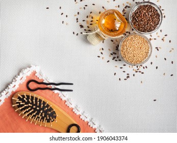 Flaxseed Oil And Seeds Are On A White Surface, A Comb And Hairpins Lie Next To An Orange Napkin. Illustration For The Use Of Flax Products For Beauty And Restoration Of Damaged Hair. View From Above 