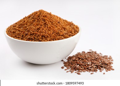 Flaxseeds ,Brown flaxseeds powder or  chutney in a ceramic bowl with whole flaxseeds