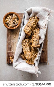 Flay Lay Tin Of Banana Granola Breakfast Bars On A Wooden Board