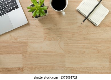 Flay lay, Top view office table desk with laptop, notebook, keyboard, coffee, pencil, leaves with copy space wood background. - Powered by Shutterstock