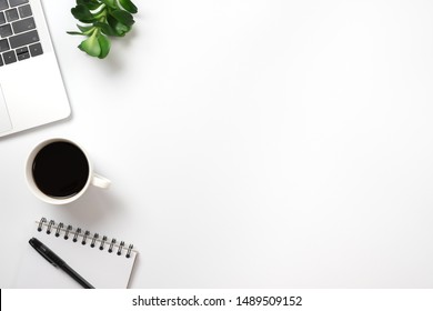 Flay lay, Top view office table desk with computer, keyboard, coffee, pencil, leaves and notepad with copy space background. - Powered by Shutterstock