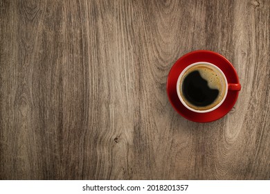 Flay Lay Wooden Desk Red Cup Of Black Coffee, Top View With Copy Space On Wooden Table