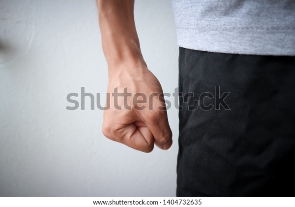 Flea angry man wearing a gray\
shirt and black pants emotionally angry anger of asian people and\
blood vessels at hand and white background texture\
objects
