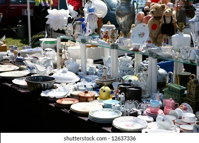 Flea Market Booth With Different Dishware On A Spring Flea Market In Bright Sunshine